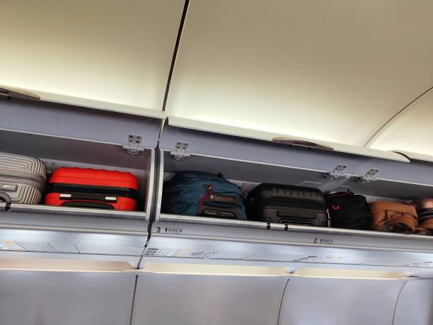 istock open airplane trunk with suitcases 1408484240