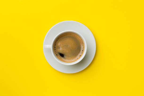 istock Cup of delicious coffee on color background, top view 1408485025