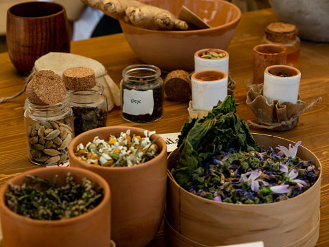 medieval reenactment - apothecary's table with various herbs and spices for body care and cooking