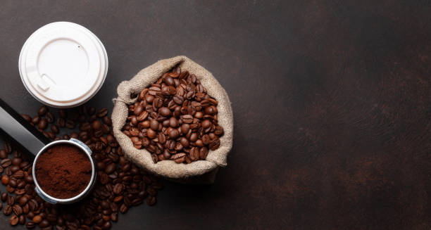 istock Takeaway cup, roasted coffee beans and ground coffee in holder 1408485733