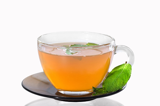 Cup of mint tea isolated on white background.