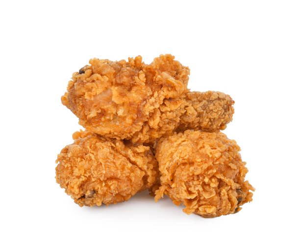 istock Heap of fried chicken legs isolated on white 1408489190