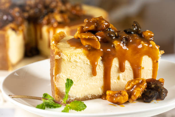istock Portion of Caramel cheesecake with nuts on white table with cutlery and nuts 1408490428
