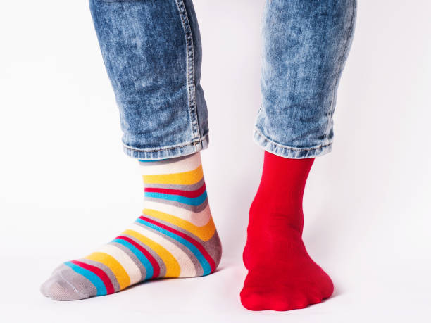 istock Men's legs and bright socks. Without shoes 1408490688