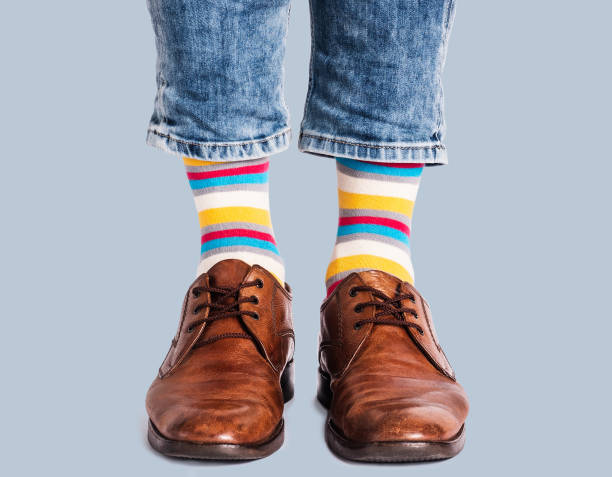 istock Men's legs, trendy shoes and bright socks 1408490780