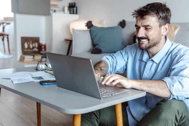istock Handsome man working on the laptop in a cozy place 1408492913