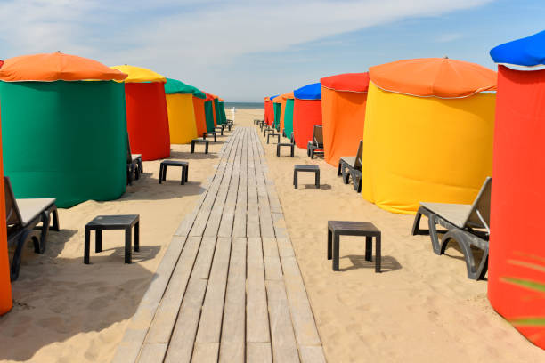 istock The typical colored tents and beach chairs 1408495804