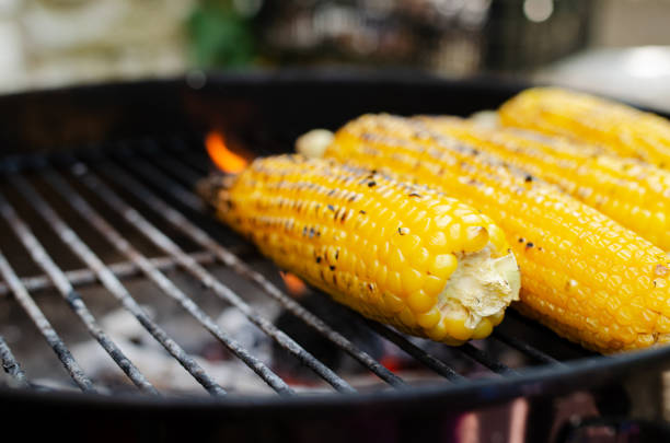 istock Four corns on the cob roasting on a grill 1408496139
