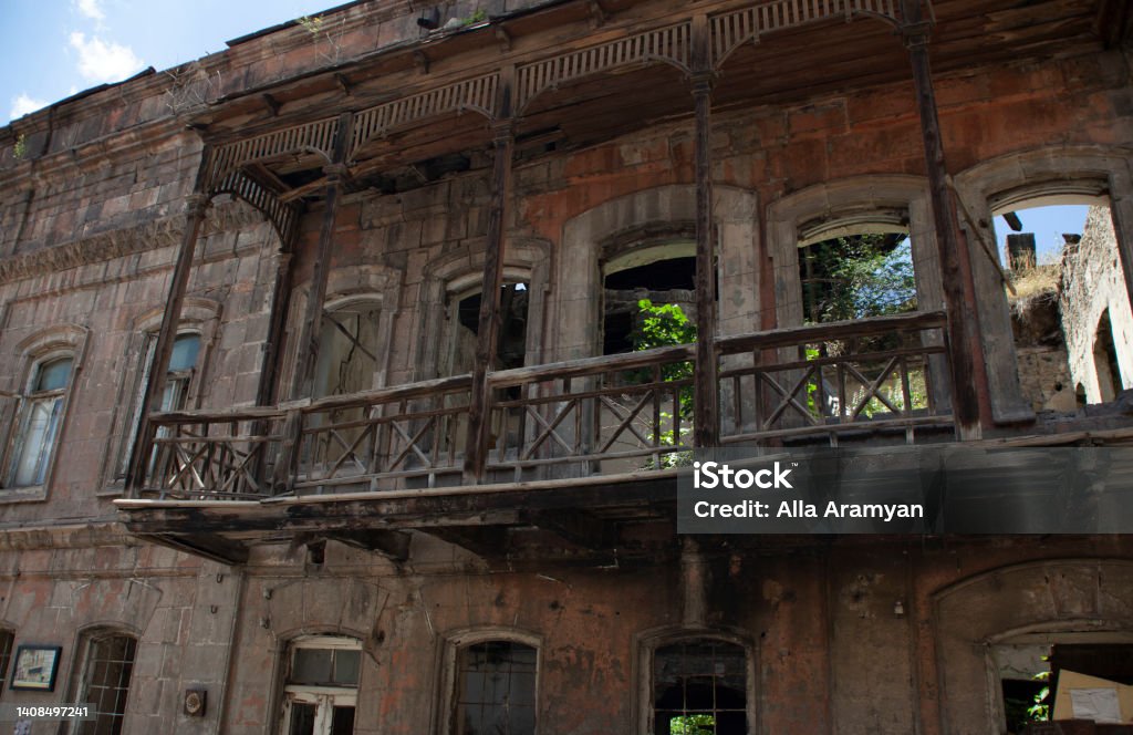 An old wooden balcony of an aged semi-destroyed building in Ajemian street, Gyumri, Armenia Ancient Stock Photo