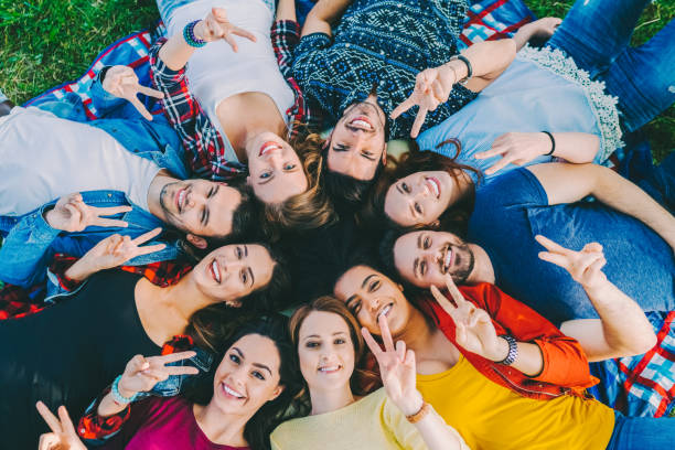 istock Friends lying on ground and smiling to the camera 1408499678