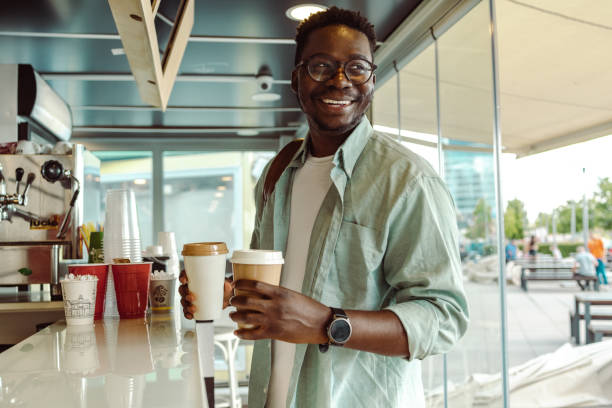 istock Cheerful African American student picking up a coffee 1408503474