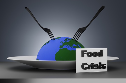 Earth globe with forks on a plate. Food crisis, world hunger concept. 3D render.