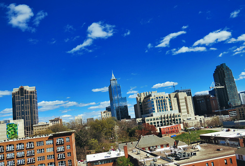 A nice urban skyline in the downtown capital city of Raleigh North Carolina on a summer day in a Dutch angle