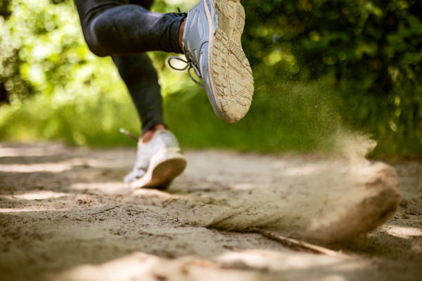 istock Unrecognizable woman running on sand 1408505316