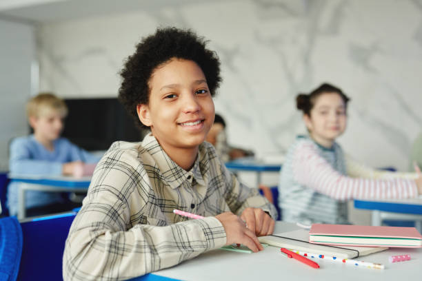 istock Smiling Black Girl in Classroom 1408507395