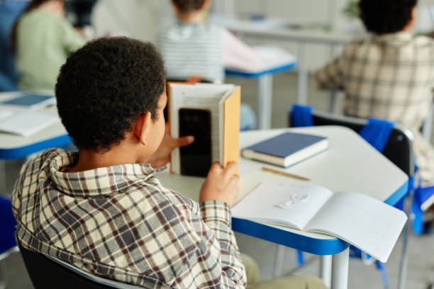 Boy Hiding Smartphone in School
