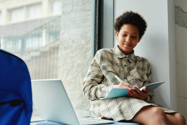 istock Girl doing Homework in School 1408507469