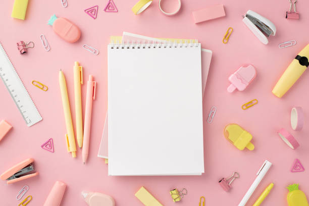 Back to school concept. Top view photo of notepads pens ice cream shaped sharpeners ruler staplers clips adhesive tape markers and pineapple shaped erasers on isolated pink background with copyspace concepto de vuelta al cole. foto de la vista superior de los blocs de notas plumas sacapuntas en forma de helado grapadoras de regla clips marcadores de cinta adhesiva y borradores en forma de piña sobre fondo rosa aislado con espacio de copia
