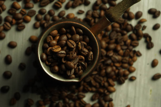 istock Black roasted coffee beans. Cezva cup coffee glass rustic style 1408508923