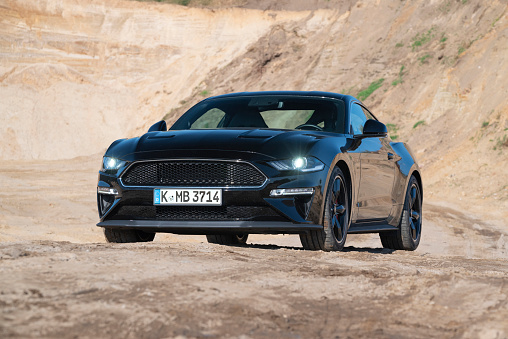 Berlin, Germany - 3rd October, 2021: Ford Mustang Bullitt on a road. This model is one of the most popular sports cars in the world.