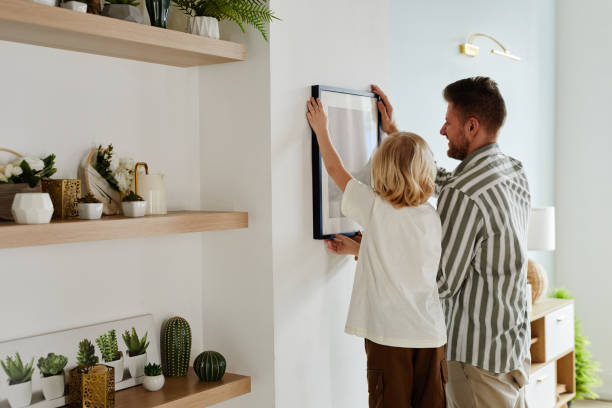 istock Happy Father and Son Hanging Picture on Wall 1408510267