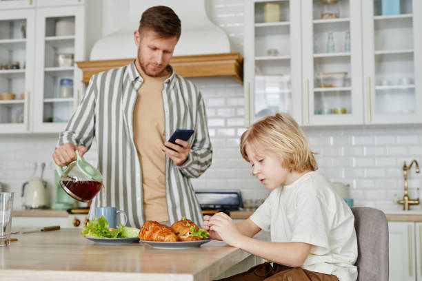 istock Boy at Breakfast with Father 1408510288