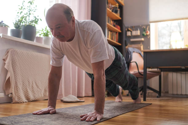 istock Cheerful senior hispanic man doing a side plank exercise at living room. 1408510840
