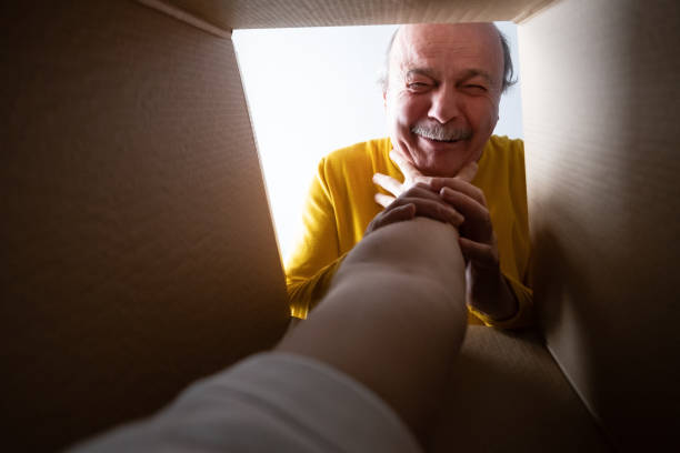istock man unpacking, opening carton box and looking inside. Somebody attack him. 1408510893