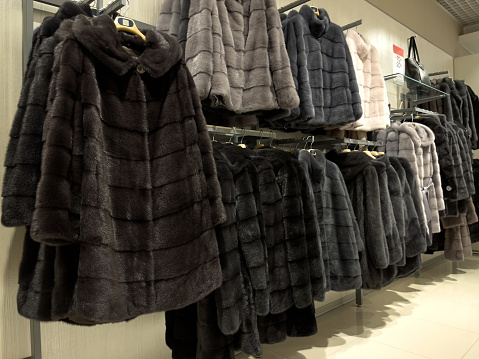 Fur coats for women in the shop display.