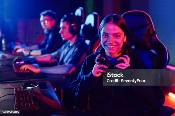 Girl In Video Game Club Stock Photo - Download Image Now - Neon Lighting, eSports, Friendship