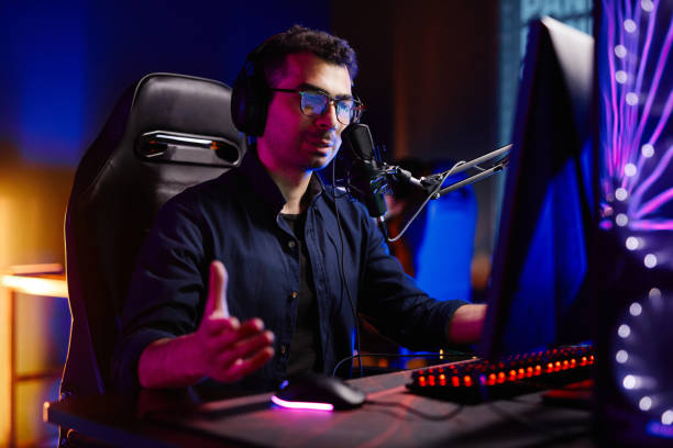 istock Man Speaking to Mic at Podcast 1408511415