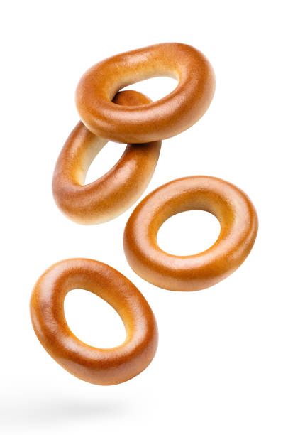 istock Flying delicious fresh bagels on white 1408512778