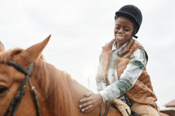 istock Young Woman Riding Horse in Sunlight 1408512817