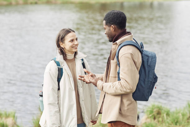 istock Multiethnic couple walking together outdoors 1408514376