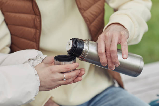 istock Young couple drinking hot tea from flask 1408514402