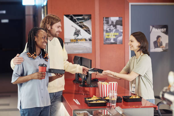 istock Young couple buying popcorn at cinema 1408514472