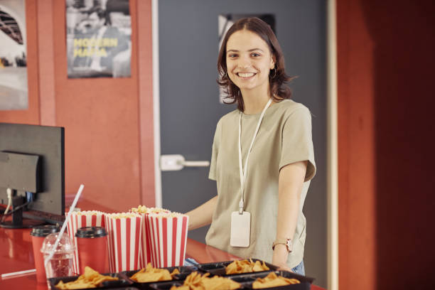 Seller selling popcorn at cinema