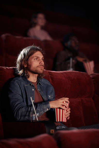 istock Man watching movie in the cinema 1408514501