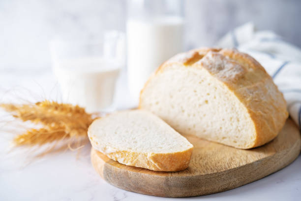 istock Wheat white bread with glasses of milk 1408516113