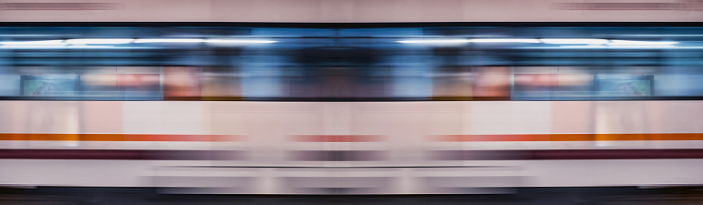 Intercity passenger train with motion blur effect on the railway platform