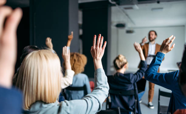 istock Business Peoples Volunteers To Answer A Question During A Seminar 1408517184