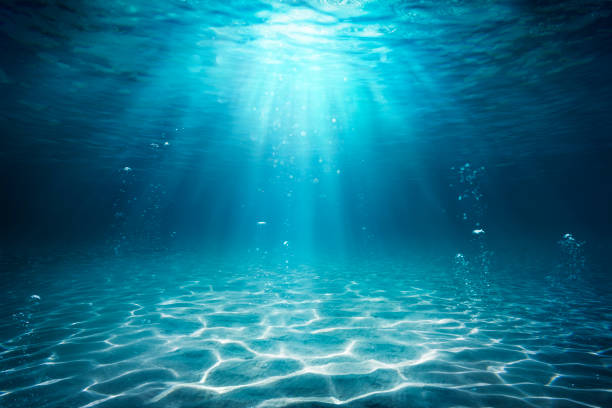 Underwater Sea - Deep Water Abyss With Blue Sun light Under water Ocean - Seabed With Sunbeam below stock pictures, royalty-free photos & images