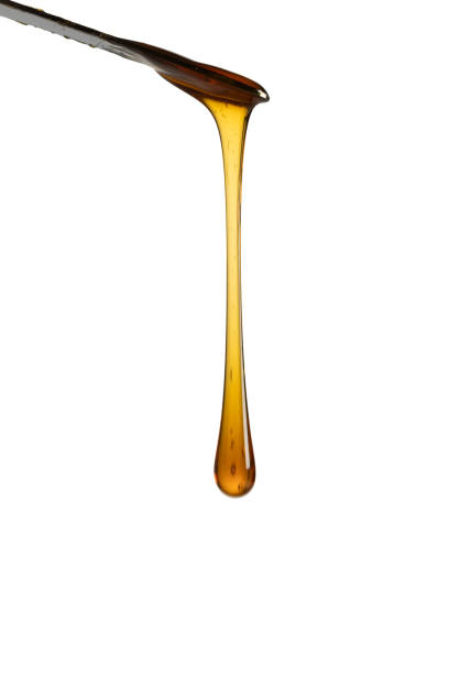 istock Dripping honey isolated on white background 1408518244