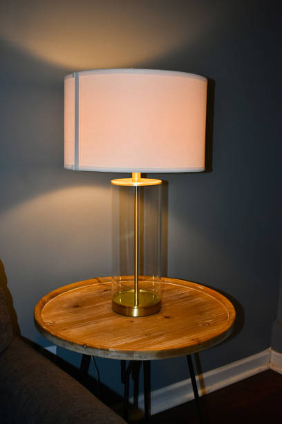 istock Wooden table and lamp in living room 1408520085