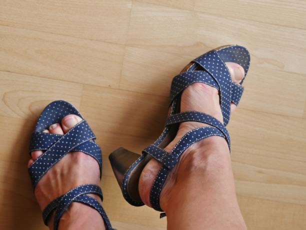 istock Women's feet in blue summer sandals 1408522845
