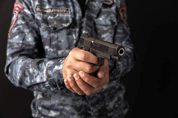 istock Military holding a gun in hand 1408525038
