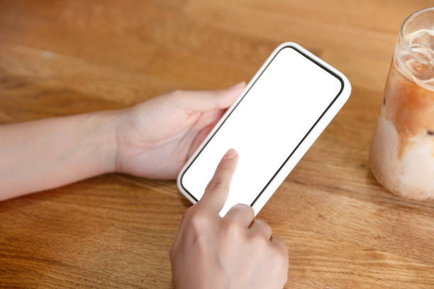 istock Female hands holding a smartphone with a blank screen 1408526121