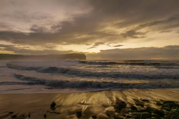 istock Sunrise at the seaside with large and powerful sets 1408529318