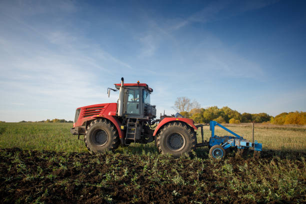 istock The tractor plows the land. Agriculture image 1408533423