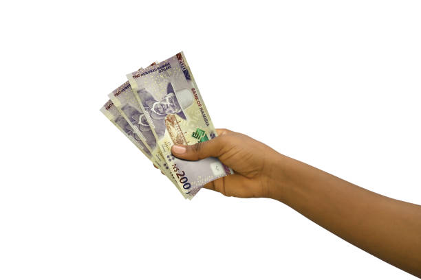 istock Fair hand holding  200 Namibian dollar notes isolated on white background 1408535148